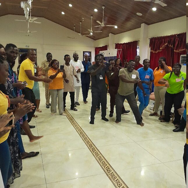 Large group standing in a collaborative construction and coordination exercise